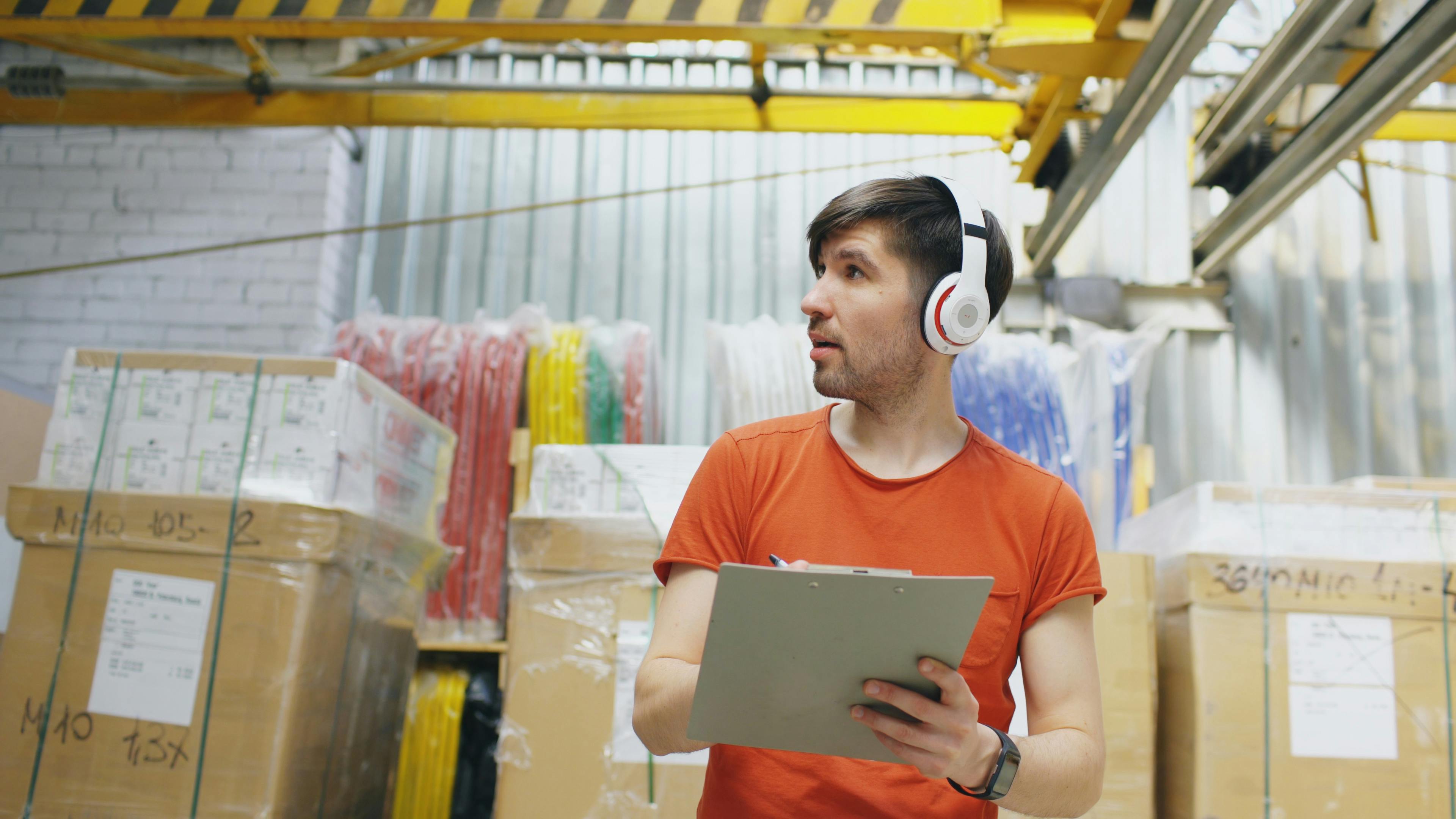 Warehouse worker reviewing an order on a clipboard